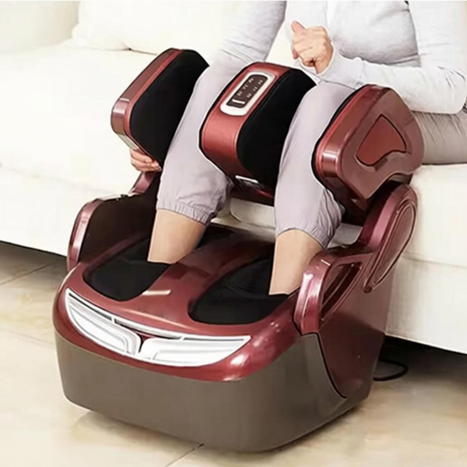 Woman seated on a sofa using the air compression leg and foot massager