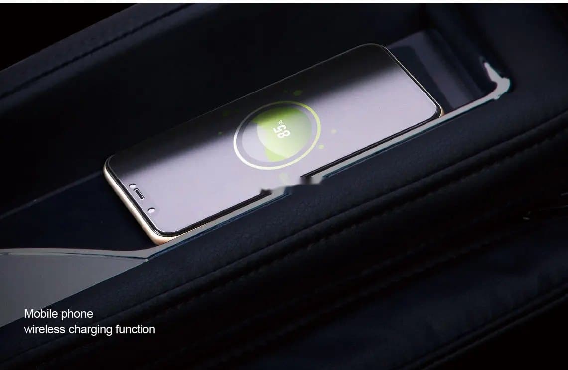 A phone charging on the Z710 Pro's wireless charging pad in the armrest